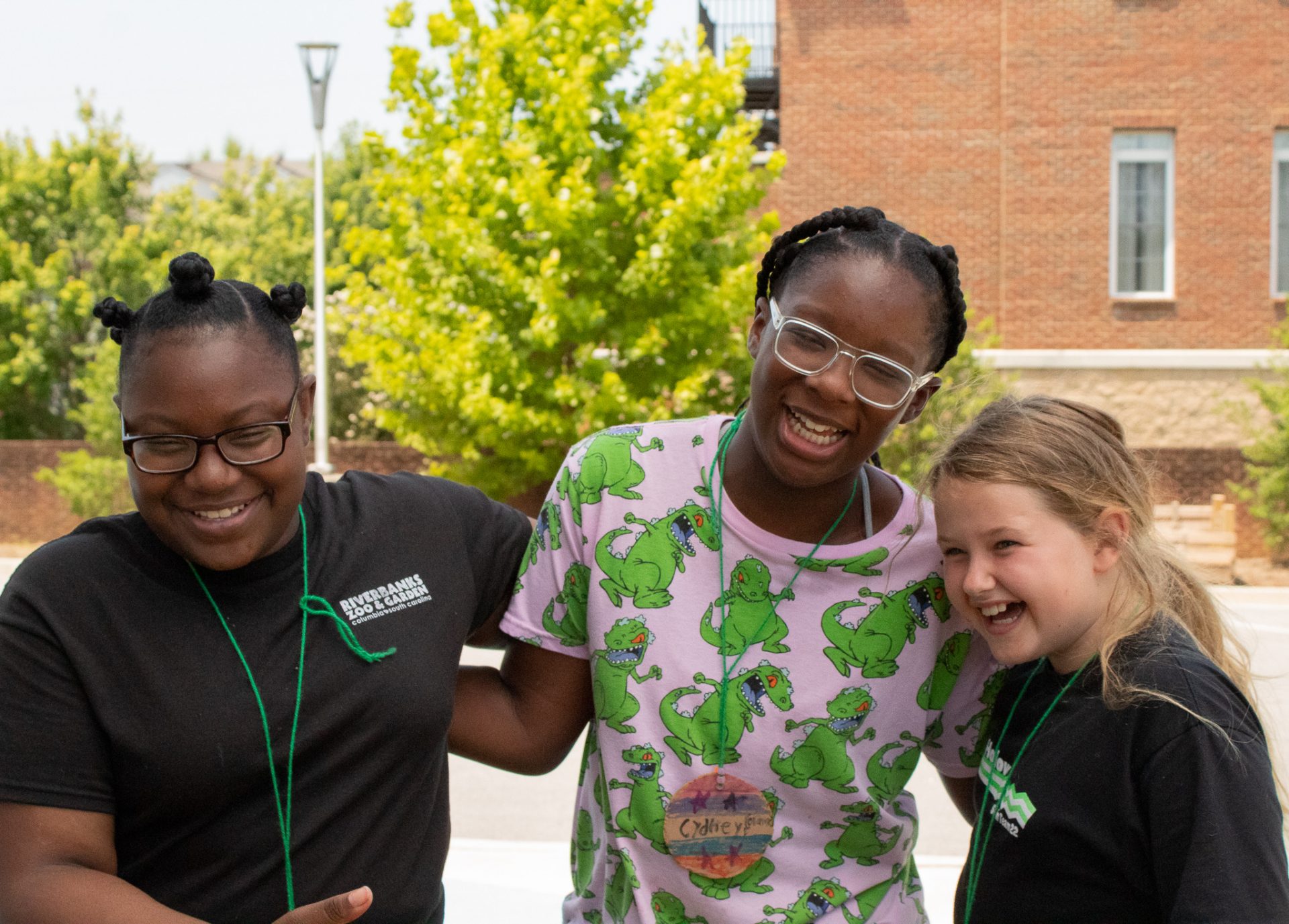  three campers laugh together at the Cathy Novinger Girl Scout Leadership Center. 