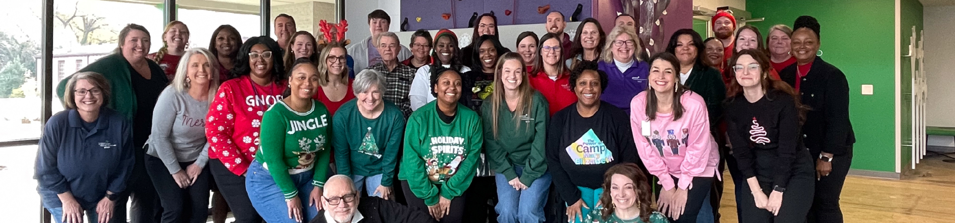  Girl Scout staff gather for group picture outside the Cathy Novinger Girl Scout Leadership Center. 