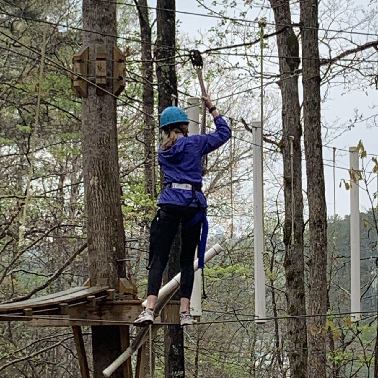 a girl scout does a rope course