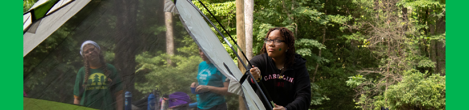  Three campers row a canoe at the Camp WaBak lake. 