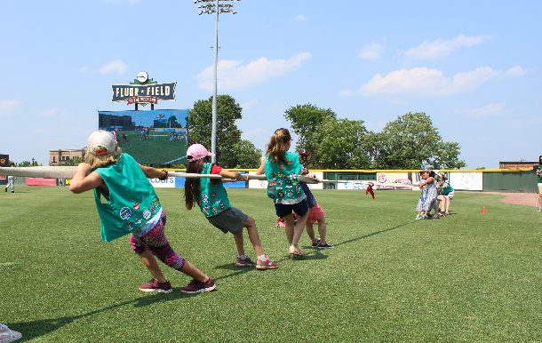 girl scouts play tug-of-war at Girl Scout Day at the Greenville Drive