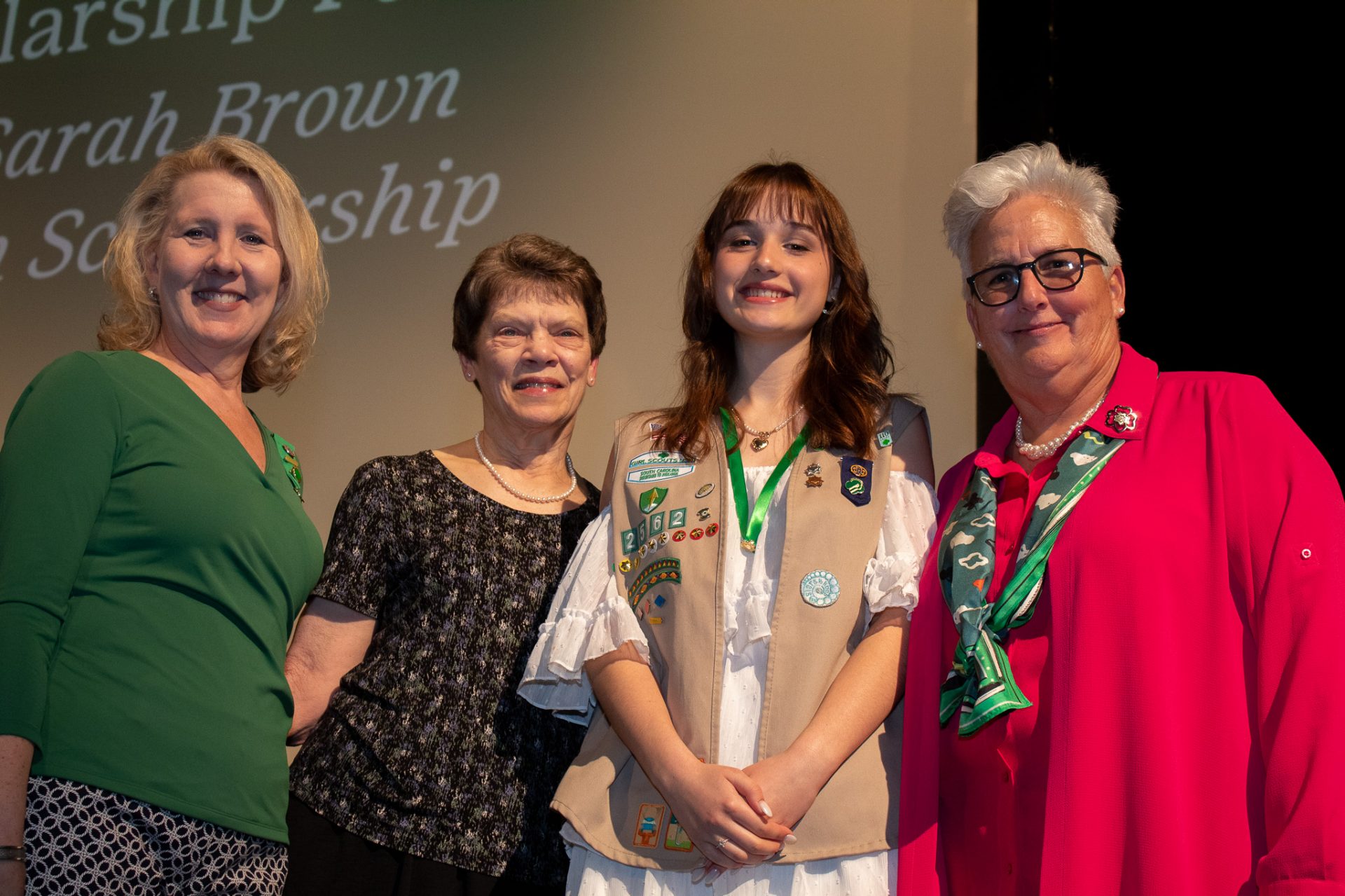 A Gold Award Girl Scout poses with her scholarship at Highest Awards Ceremony.