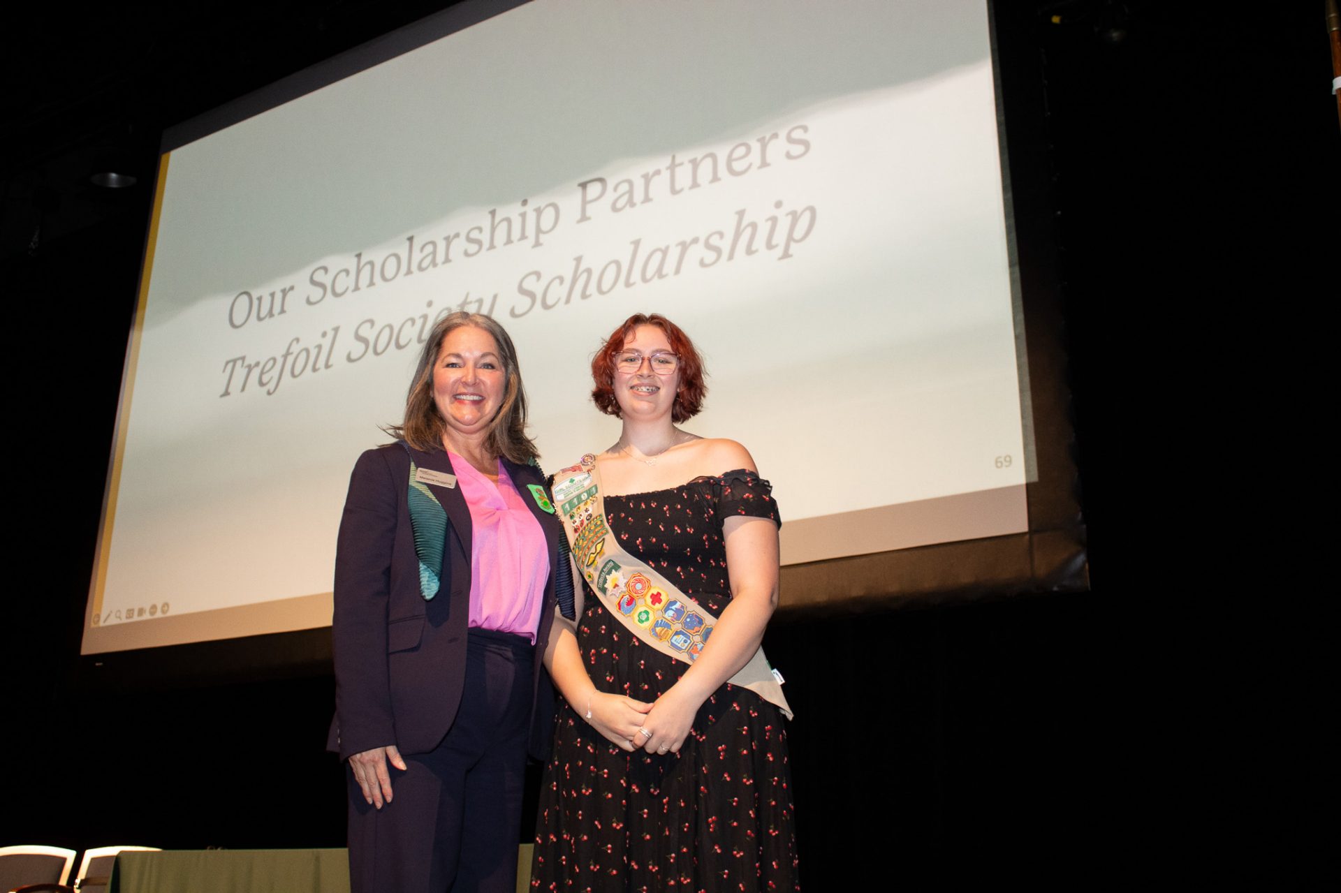 A Gold Award Girl Scout poses with her scholarship at Highest Awards Ceremony.