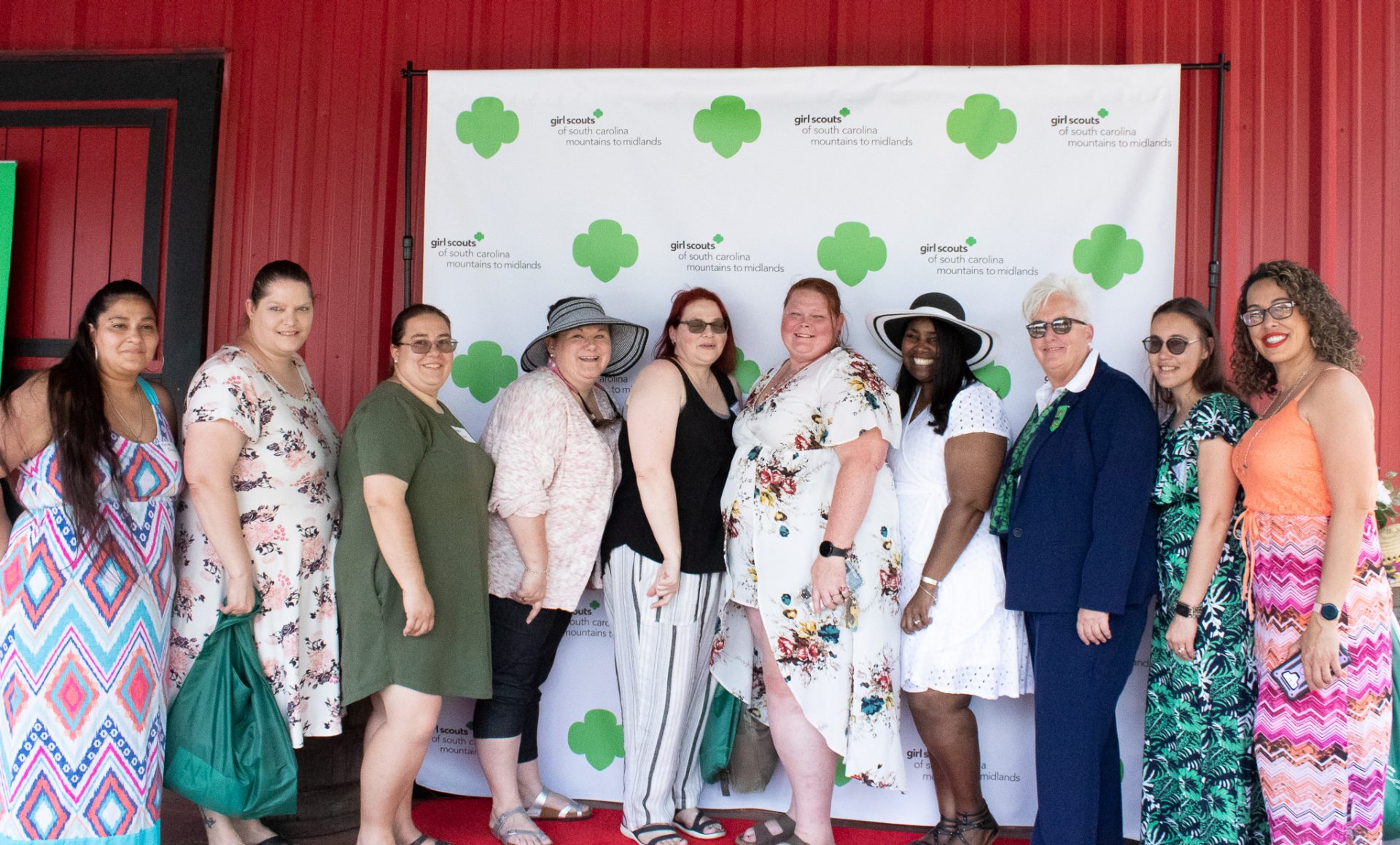  nine volunteers pose with CEO Lora Tucker at the 2022 Volunteer Appreciation Ceremony. 