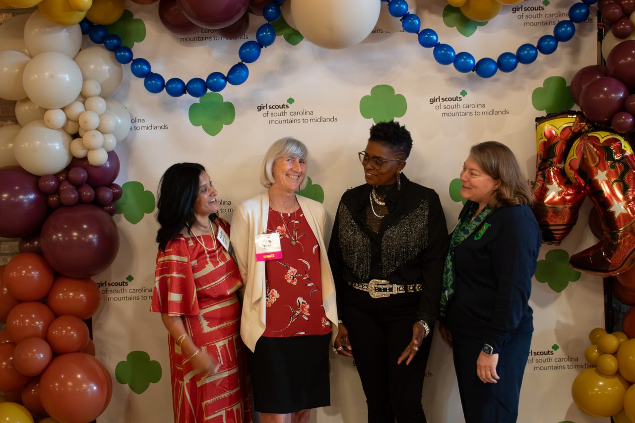 two honorees pose with Board Chair Kavita Borsum and COO Lynn Arve